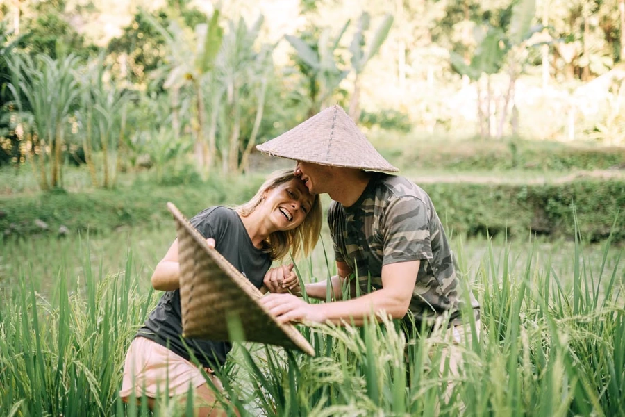 Couple enjoying a meaningful private travel experience in an Asian rice field